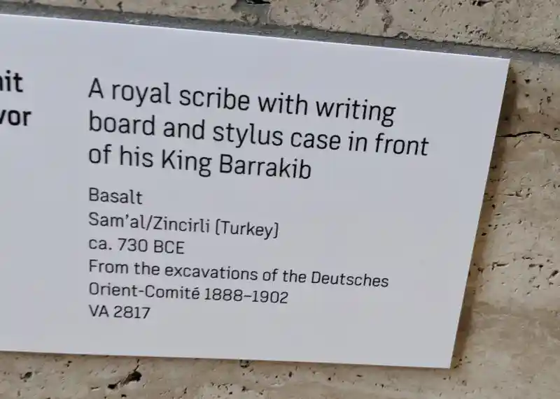 A royal scribe with writing board and stylus case in front of his King Barrakib, Pergamon Museum, Museum Island, Berlin